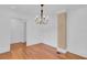 Dining room featuring hardwood floors, chandelier, and a decorative brick element at 1021 S Elm Ave, Sanford, FL 32771