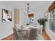 Dining room with round table, six chairs, modern chandelier, and art at 1021 S Elm Ave, Sanford, FL 32771