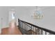 Hallway with a view of a gold chandelier and hardwood floors at 1021 S Elm Ave, Sanford, FL 32771