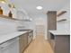 Contemporary kitchen showcasing gray cabinets, white countertops, stainless steel appliances, and stylish lighting fixtures at 1021 S Elm Ave, Sanford, FL 32771