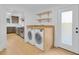 Convenient laundry room features modern appliances, butcher block countertop, and kitchen access at 1021 S Elm Ave, Sanford, FL 32771