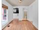 Living room displaying wood floors with stair access and a window at 1021 S Elm Ave, Sanford, FL 32771