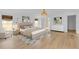 Bright main bedroom features wood floors, neutral tones, modern decor, and ample natural light, creating a serene retreat at 1021 S Elm Ave, Sanford, FL 32771