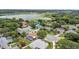An aerial view of a neighborhood with mature trees and a lake in the background at 1103 Lake Legro Ct, Orlando, FL 32835