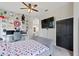 This bedroom has a ceiling fan, built-in desk, dark doors and fun decor creates a unique haven at 1103 Lake Legro Ct, Orlando, FL 32835