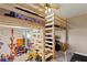 The bedroom features a loft bed with stairs surrounded by play and learning areas at 1103 Lake Legro Ct, Orlando, FL 32835