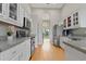 Bright kitchen featuring white cabinets, stainless steel appliances, and hardwood floors at 1103 Lake Legro Ct, Orlando, FL 32835