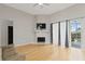 Bright living room featuring fireplace, sliding glass doors to patio, and hardwood floors at 1103 Lake Legro Ct, Orlando, FL 32835