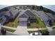 Aerial front view of a well maintained single Gathering home with a lawn, driveway and a two car garage at 1105 Citrus Landings Blvd, Davenport, FL 33837