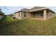 Beautiful backyard with a covered patio area and expansive green lawn at 1105 Citrus Landings Blvd, Davenport, FL 33837