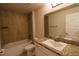 Well-lit bathroom featuring a tub-shower combo and a vanity with storage at 1105 Citrus Landings Blvd, Davenport, FL 33837