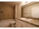 Well-lit bathroom featuring a tub-shower combo and a vanity with storage at 1105 Citrus Landings Blvd, Davenport, FL 33837