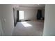 A spacious bedroom with plush carpet, curtains, and ample natural light from a window at 1105 Citrus Landings Blvd, Davenport, FL 33837