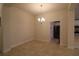 Neutral dining room with chandelier lighting, tile flooring and an open doorway at 1105 Citrus Landings Blvd, Davenport, FL 33837