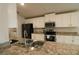 This kitchen features white cabinetry, stainless steel appliances and a spacious double sink at 1105 Citrus Landings Blvd, Davenport, FL 33837