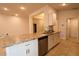 Open kitchen with island counter, stainless steel appliances, and white cabinetry at 1105 Citrus Landings Blvd, Davenport, FL 33837