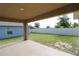 Covered patio overlooking a spacious, fenced backyard with a well-maintained lawn at 1105 Citrus Landings Blvd, Davenport, FL 33837
