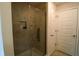 A modern tiled shower with glass door and built-in shelving for bath accessories at 1105 Citrus Landings Blvd, Davenport, FL 33837