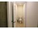 A clean, well-maintained toilet in a small, tiled bathroom space with white walls at 1105 Citrus Landings Blvd, Davenport, FL 33837
