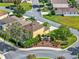 Aerial view showcasing the property's landscaping near community signage in a suburban neighborhood at 12347 Ne 52Nd Loop, Oxford, FL 34484