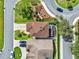 Aerial view of a home with a spacious driveway, screened enclosure and manicured landscaping at 12347 Ne 52Nd Loop, Oxford, FL 34484