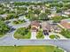 An aerial view shows a bright yellow two-story home with attached garage at 12347 Ne 52Nd Loop, Oxford, FL 34484