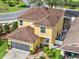 Aerial view of two-story home with well-maintained landscaping and screened patio at 12347 Ne 52Nd Loop, Oxford, FL 34484