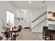 Bright entryway with laminate flooring, a staircase, and a white front door at 12347 Ne 52Nd Loop, Oxford, FL 34484