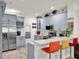 Bright kitchen showcasing blue cabinets, white countertops, stainless steel appliances, and bar-style seating at 12347 Ne 52Nd Loop, Oxford, FL 34484