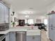 Beautiful kitchen with an open view to the dining and living areas, stainless steel appliances and stylish countertops at 12347 Ne 52Nd Loop, Oxford, FL 34484