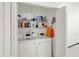 Organized laundry closet with appliances and shelving for storage at 12347 Ne 52Nd Loop, Oxford, FL 34484