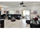 Expansive living room featuring neutral walls, wood-look flooring, and access to the outdoor patio at 12347 Ne 52Nd Loop, Oxford, FL 34484