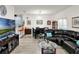 Inviting living room featuring modern decor, wood-look flooring, and dining area with black table set at 12347 Ne 52Nd Loop, Oxford, FL 34484