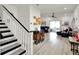 Open living space with laminate flooring, staircase, and bright windows for ample natural light at 12347 Ne 52Nd Loop, Oxford, FL 34484