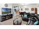 Inviting living room featuring modern decor, wood-look flooring, and dining area with black table set at 12347 Ne 52Nd Loop, Oxford, FL 34484