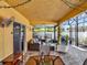 Inviting screened-in patio featuring stylish furniture and outdoor fan at 12347 Ne 52Nd Loop, Oxford, FL 34484