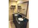 Elegant bathroom featuring a double vanity with dark cabinets and a large mirror at 139 Stoney Ridge Dr, Longwood, FL 32750
