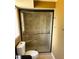 Modern bathroom featuring a tiled walk-in shower with a glass door and a built-in seat at 139 Stoney Ridge Dr, Longwood, FL 32750