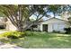 Charming single-story home featuring a stone facade, lush lawn, and a mature shade tree at 139 Stoney Ridge Dr, Longwood, FL 32750