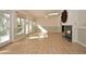 Spacious living room boasts tile flooring, fireplace, natural light, and an inviting ambiance at 139 Stoney Ridge Dr, Longwood, FL 32750