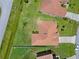 Aerial view of the home shows the roof, surrounding landscaping, and driveway at 1457 Teal Dr, Kissimmee, FL 34759