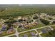 An aerial view of a neighborhood surrounded by lush trees and greenery at 1457 Teal Dr, Kissimmee, FL 34759