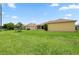 Sprawling backyard featuring lush green grass and exterior building that matches the house at 1457 Teal Dr, Kissimmee, FL 34759