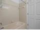 Cozy bathroom featuring a tub and shower with tiled walls at 1457 Teal Dr, Kissimmee, FL 34759