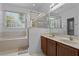 Relaxing bathroom with soaking tub, glass shower, and double sinks at 1457 Teal Dr, Kissimmee, FL 34759