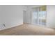 Bedroom features neutral colored walls, carpet and slider to the outdoors at 1457 Teal Dr, Kissimmee, FL 34759