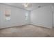Bright bedroom features two windows, neutral carpet, ceiling fan, and freshly painted walls at 1457 Teal Dr, Kissimmee, FL 34759