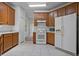 Well-lit kitchen with ample wood cabinet space and white appliances at 1457 Teal Dr, Kissimmee, FL 34759