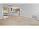 Open-concept living area with tile floors flowing into a kitchen with wood cabinets and appliances at 1457 Teal Dr, Kissimmee, FL 34759