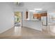 Bright living area with tile flooring transitioning to kitchen, and sliding doors to outdoor space at 1457 Teal Dr, Kissimmee, FL 34759